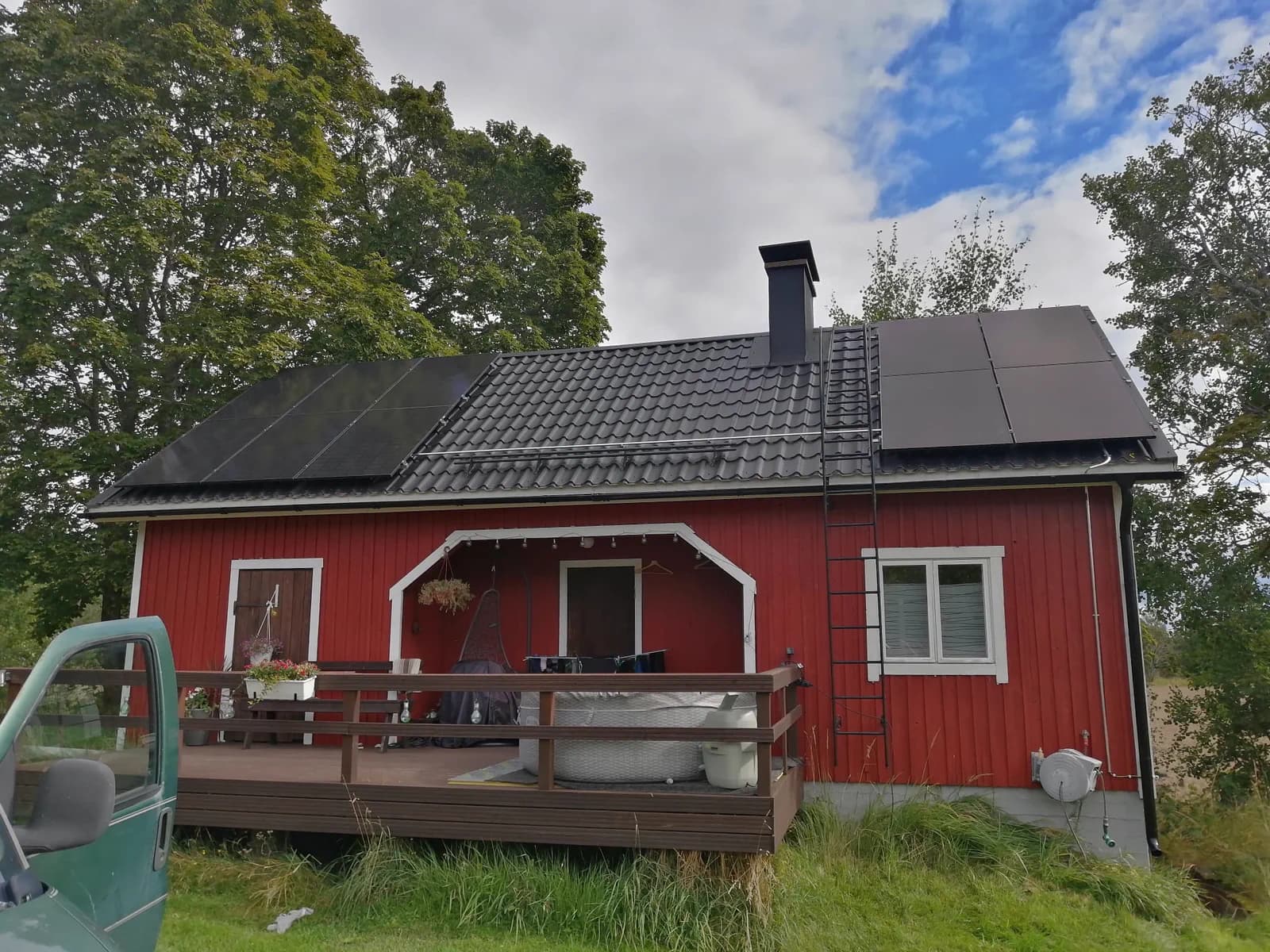 Solar panels on the roof of a red wooden house
